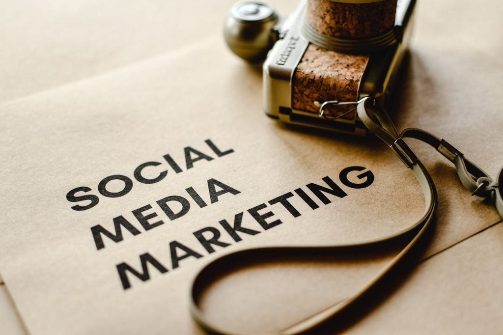 Close-up of a camera placed on brown paper with Social Media Marketing text, emphasizing digital marketing themes.